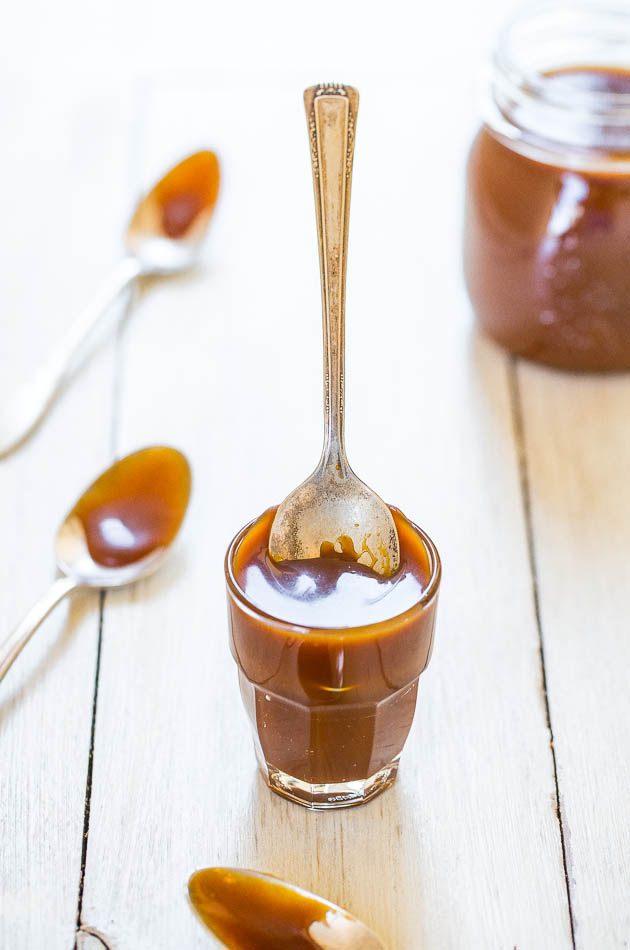 homemade Caramel Sauce in glass with spoon