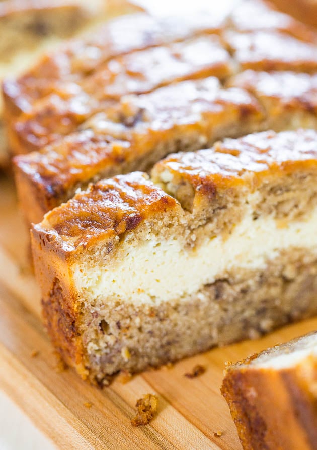 Cream Cheese-Filled Banana Bread — This is the BEST homemade banana bread recipe! This banana bread tastes like it has cheesecake baked in! Soft, fluffy, easy and tastes ahhhh-mazing!!