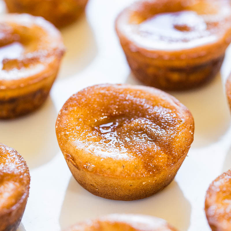 Freshly baked pastries with a glossy glaze on a white surface.