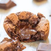 A molten chocolate chip cookie with a gooey center, surrounded by pieces of chocolate.