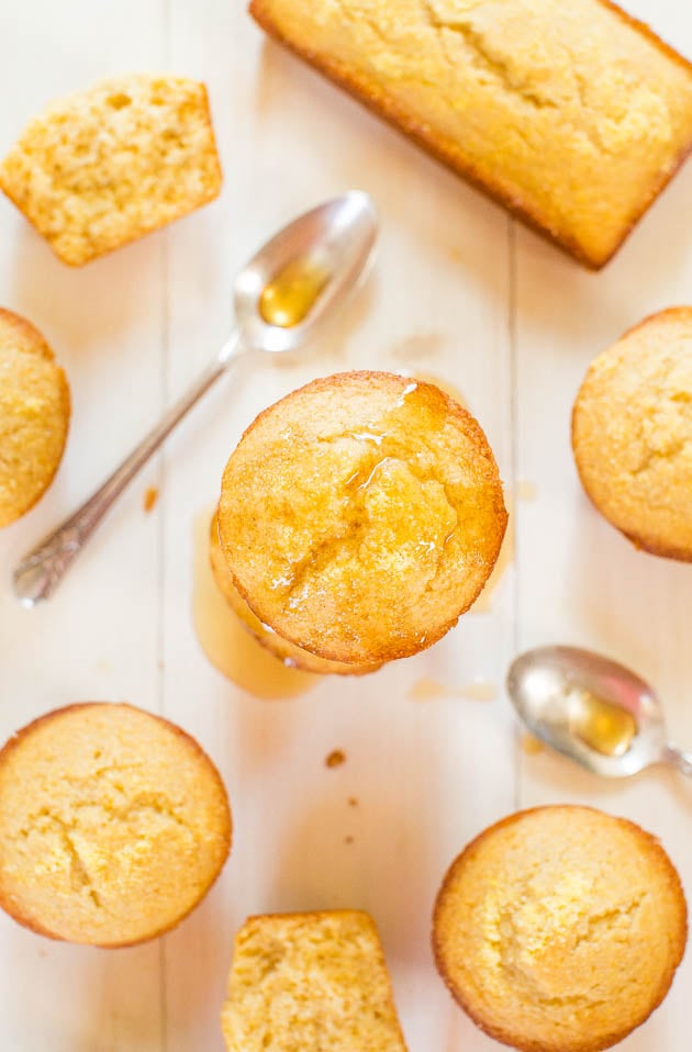 sweet Cornbread Muffins on countertop with 2 spoons