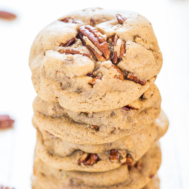 A stack of pecan cookies on a white surface.