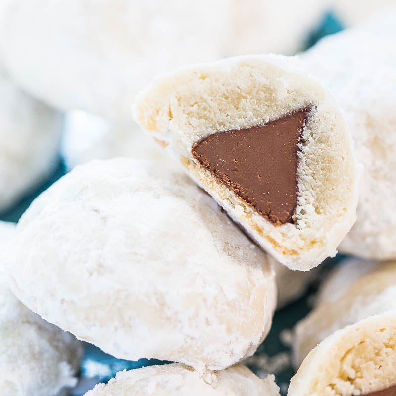 Powdered sugar-coated cookies with a chocolate center.