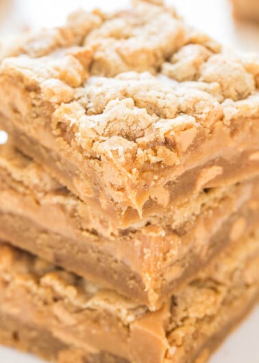 A stack of freshly baked, crumbly peanut butter bars.