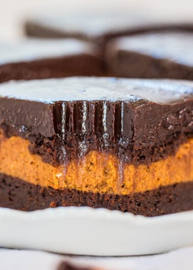 A slice of chocolate pumpkin cake with a glossy ganache topping.