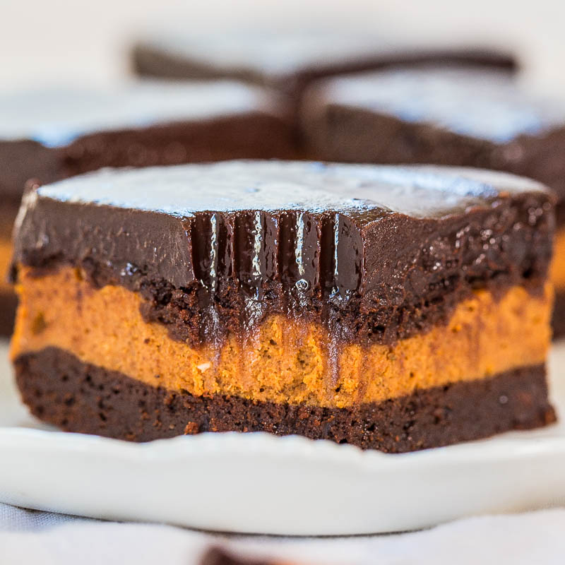 A slice of chocolate pumpkin cake with a glossy ganache topping.