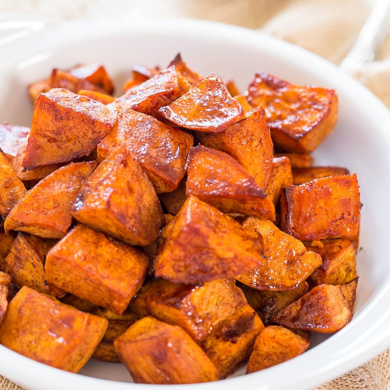 A bowl of roasted sweet potatoes seasoned with spices.