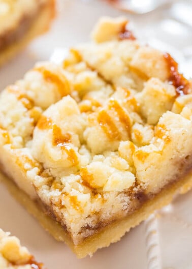 A close-up of a crumb-topped pie slice on a plate.