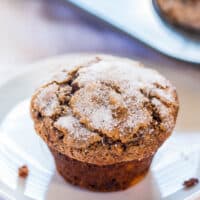 A sugar-topped muffin on a white plate.