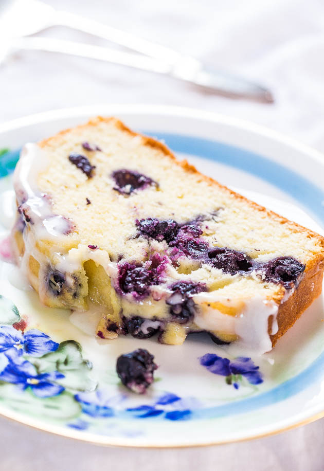 Glazed Lemon Blueberry Pound Cake — Each bite is studded with juicy blueberries, and the sweet-tart lemon glaze takes this pound cake to the next level! Say goodbye to dry, flavorless pound cakes! 
