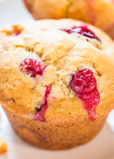 Freshly baked raspberry muffin with visible berries.