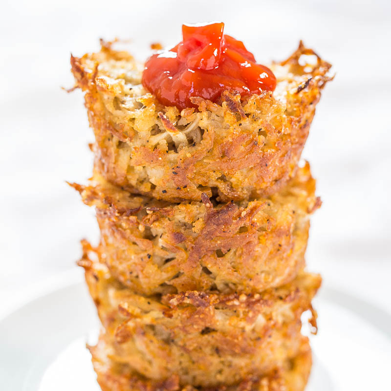 Stack of crispy hash browns topped with a dollop of ketchup.