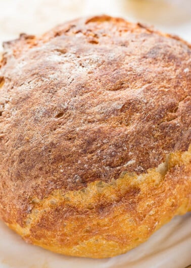 A freshly baked round loaf of bread with a golden-brown crust.