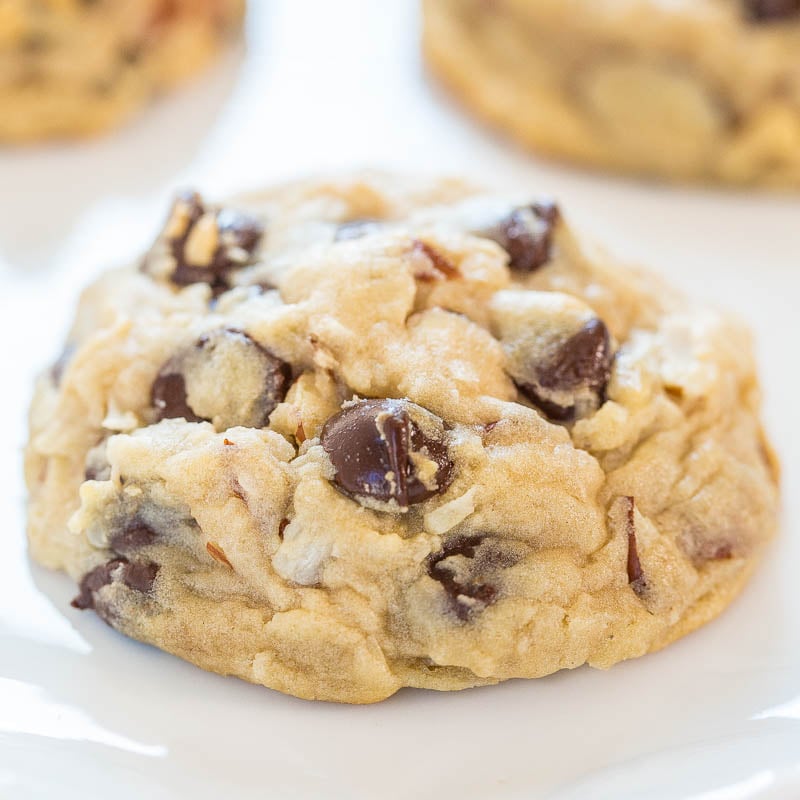 Close-up of a chocolate chip cookie with visible chocolate chunks and a golden-brown texture.