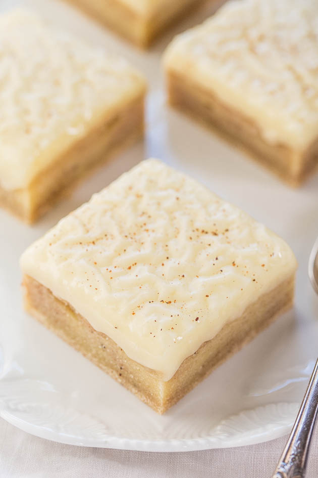 four eggnog cookie bars on a white platter 