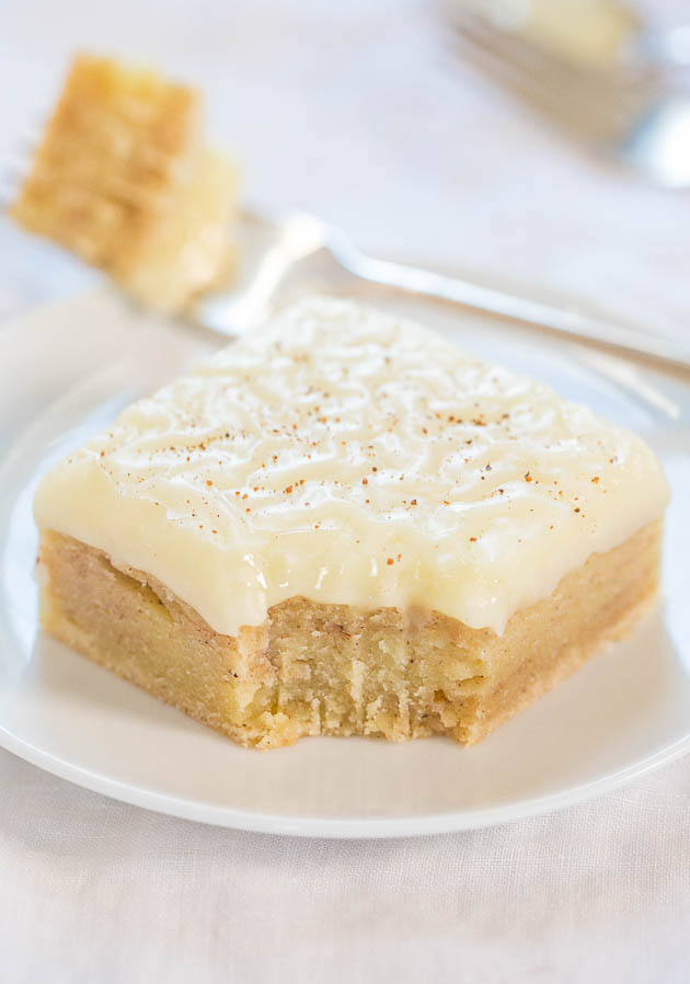 an eggnog bar on a white plate. a bite is missing. 