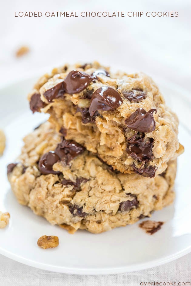 two oatmeal coconut chocolate chip cookies stacked on a white plate