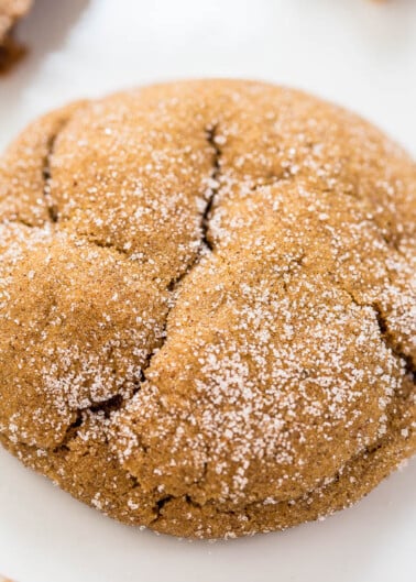 Close-up of a sugar-coated ginger cookie on a white surface.