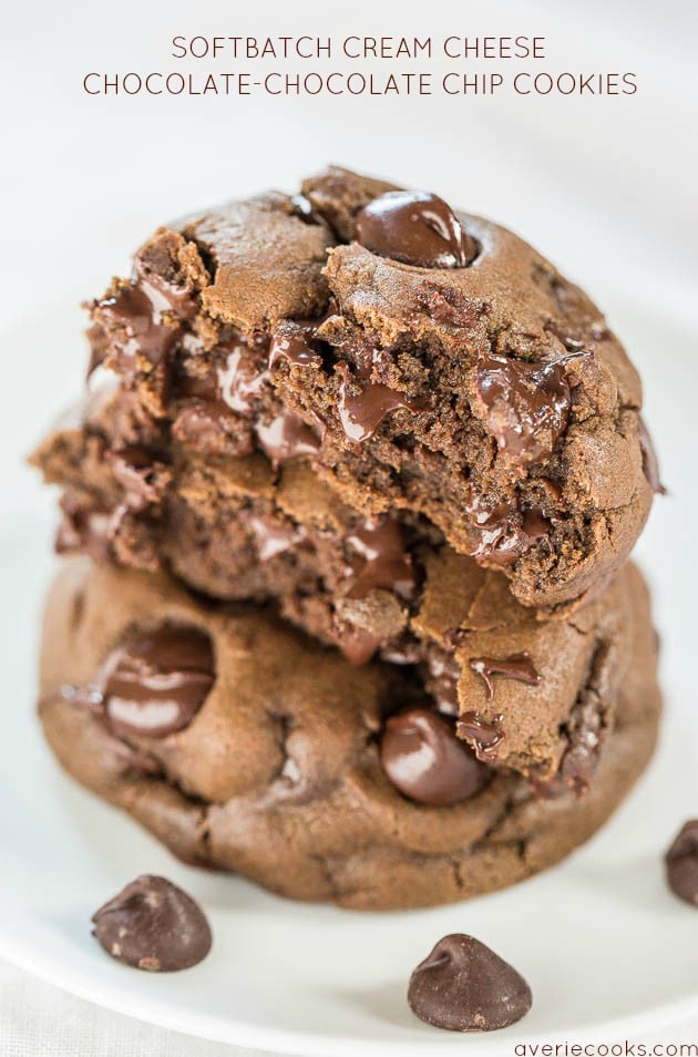 stack of three chocolate chocolate chip cookies on white plate