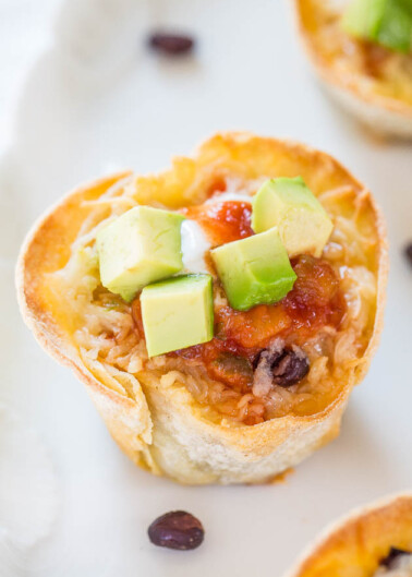 Mexican-inspired cup with rice, beans, cheese, salsa, and diced avocado.
