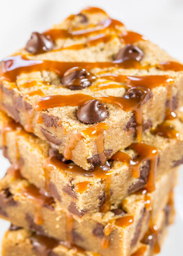 Stack of chocolate chip blondies drizzled with caramel sauce.