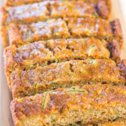 Sliced zucchini bread on a wooden board.