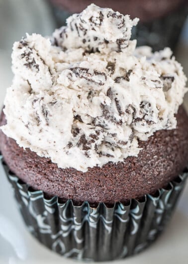 A chocolate cupcake topped with cookies and cream frosting.