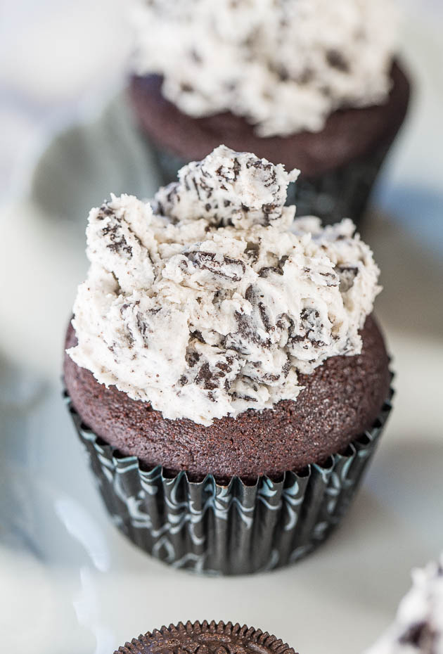 Cookies and Cream Cupcakes — Soft, fluffy chocolate cupcakes with Oreo frosting you'll want to eat by the spoonful! Ready in under an hour, and perfect for birthdays, parties, and family gatherings! 