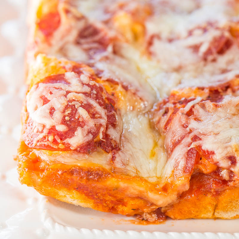 A close-up of a slice of pepperoni pizza with melted cheese.
