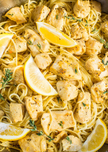 A dish of lemon chicken pasta sprinkled with herbs in a cooking pot.
