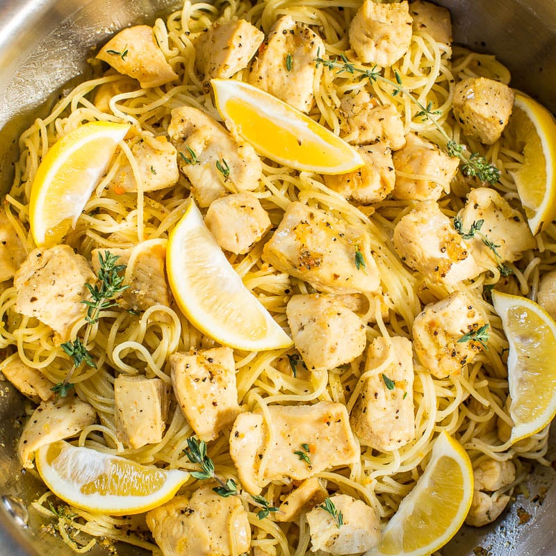 A dish of lemon chicken pasta sprinkled with herbs in a cooking pot.