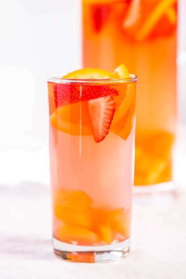 glass of spiked punch with fresh fruit 