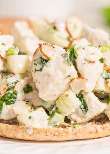 Chicken salad with almonds and celery served on a whole grain cracker.
