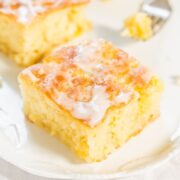 A freshly baked piece of cornbread topped with melting butter and honey.