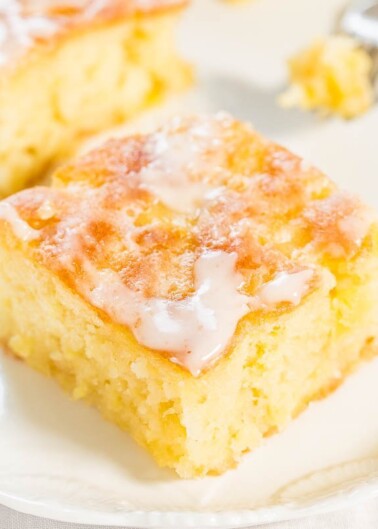 A freshly baked piece of cornbread topped with melting butter and honey.