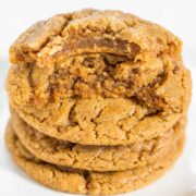 A stack of three golden-brown, chewy cookies against a white background.