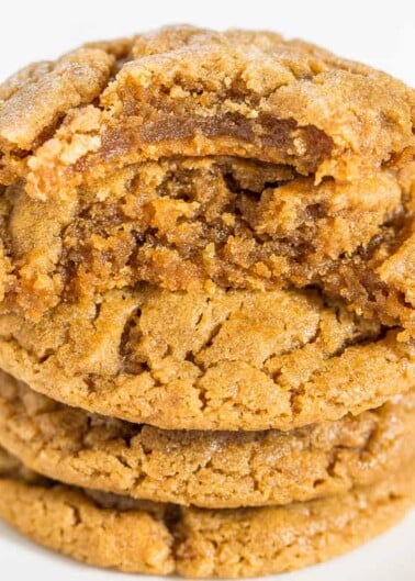 A stack of three golden-brown, chewy cookies against a white background.