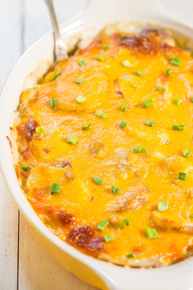Cheesy Loaded Scalloped Potatoes - Baked with sour cream, green onions and topped with cheese! Easy comfort food that everyone loves! It'll be your new favorite recipe for scalloped potatoes!!