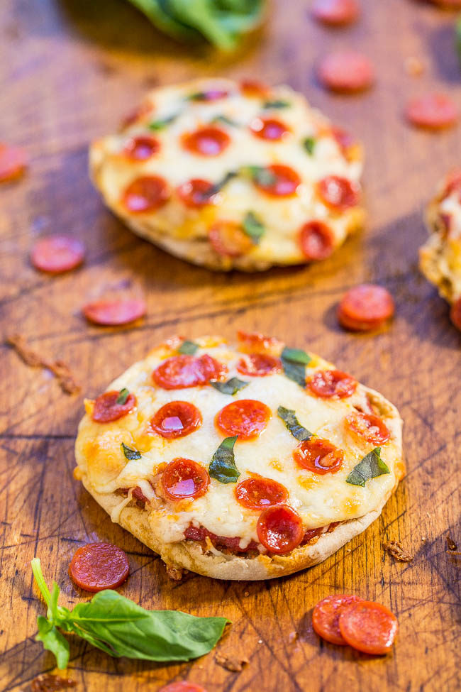 Mini pepperoni pizzas on a wooden board