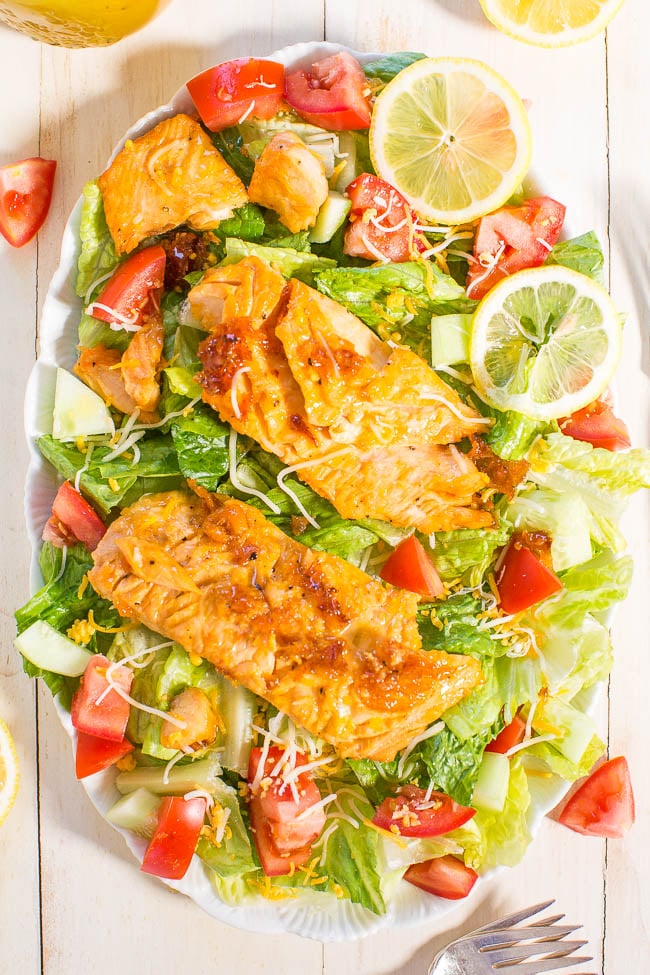 Easy Green Salad with Salmon — Ready in 15 minutes and can easily be meal prepped! My whole family loves this recipe and said it's their favorite salmon salad I've ever made! You'll want to slurp up the honey lemon dressing! 