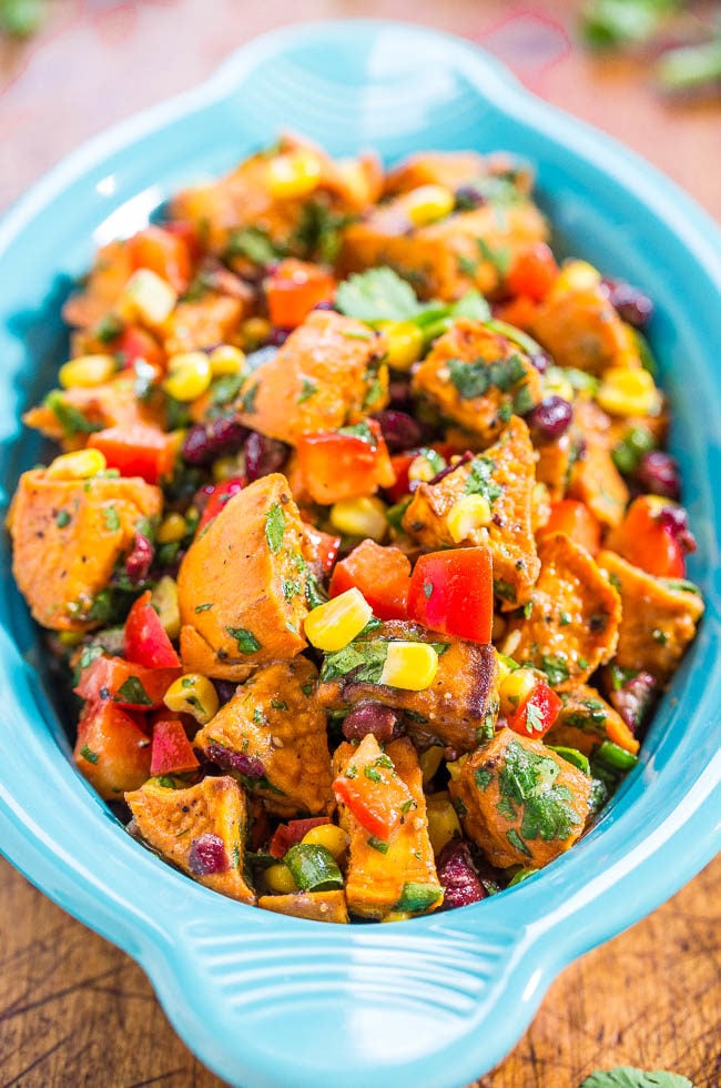 Roasted Sweet Potato Salad - Goodbye mayo-loaded, mushy, boring potato salad. Hello to a Mexican-inspired potato salad full of flavor and texture with corn, black beans, peppers, and cilantro!! (Great for outdoor events and lunchboxes because there's no mayo!)