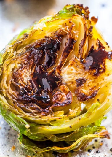 A close-up of a roasted brussels sprout with charred edges.