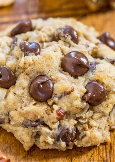 Close-up of a chocolate chip cookie on a wooden surface.