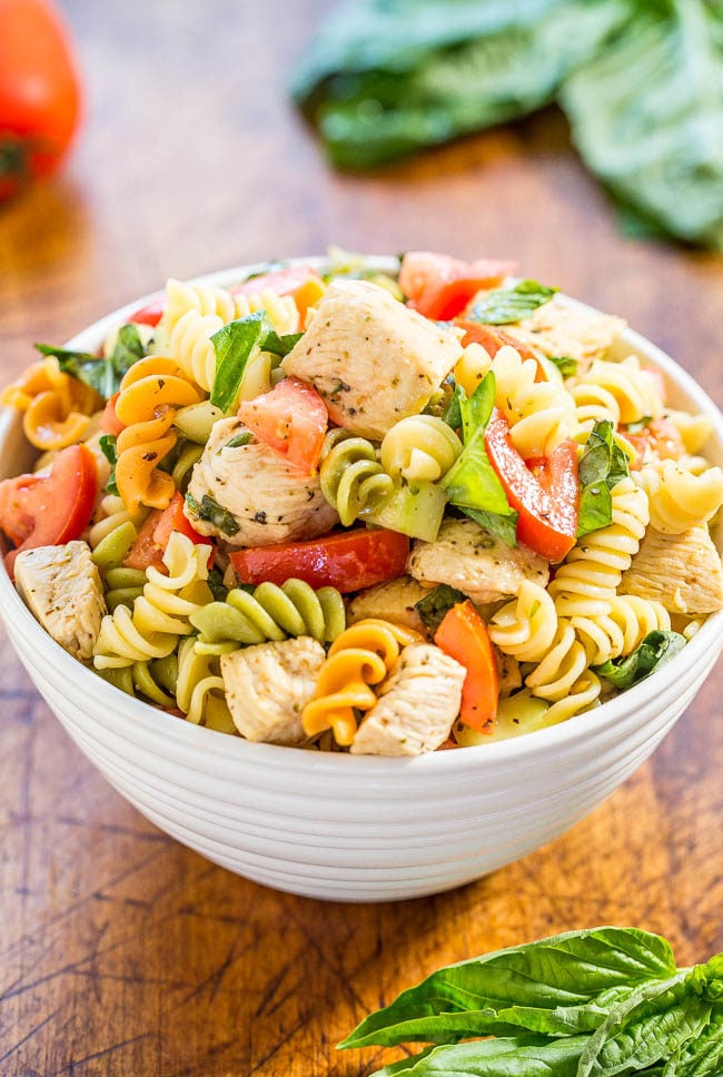 Italian Chicken Pasta Salad - Easy, ready in 20 minutes, and healthy! Bursting with fresh flavors from juicy tomatoes, cucumber, basil, parmesan, and tender chicken tossed in a tangy lemon vinaigrette!! 
