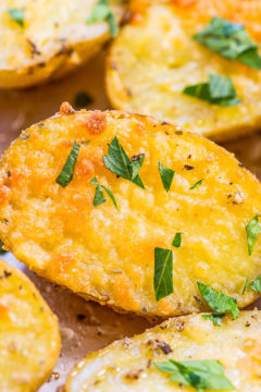 Roasted potato halves garnished with herbs.