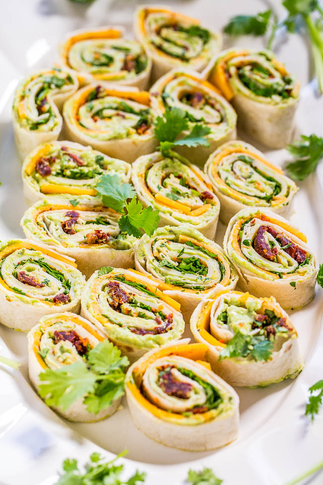 Chipotle Cheddar Avocado Tortilla Pinwheels — Creamy avocado with sharp cheddar, cilantro, and a little bit of smoky chipotle heat! Easy, ready in 5 minutes, and everyone loves these! Great appetizer and a gameday party favorite!!