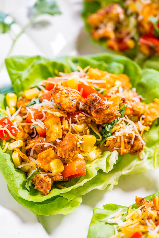 Chicken Taco Lettuce Wraps — Filled with Mexican flavors, there's taco-seasoned chicken, tomatoes, corn, peppers, cilantro, and cheese! Easy, healthy, ready in 10 minutes, and a family favorite!!