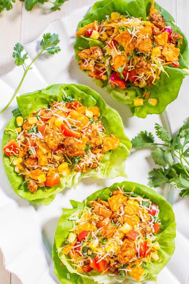 Chicken Taco Lettuce Wraps — Filled with Mexican flavors, there's taco-seasoned chicken, tomatoes, corn, peppers, cilantro, and cheese! Easy, healthy, ready in 10 minutes, and a family favorite!!