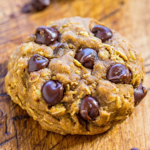A chocolate chip cookie on a wooden surface.