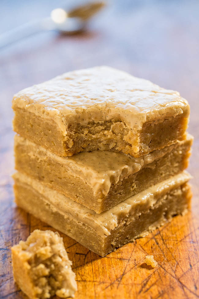 Three stacked Vanilla Bean Caramel Blondies with bite taken out of one